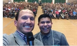 Kevin taking a selfie with a packed audience in the background