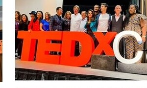 Kevin on a TEDx stage with the TEDx Cape May letters
